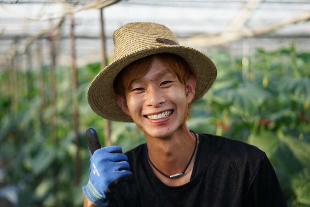 きゅうりのハウスで笑顔を見せる羽佐田裕紀（はっしー）